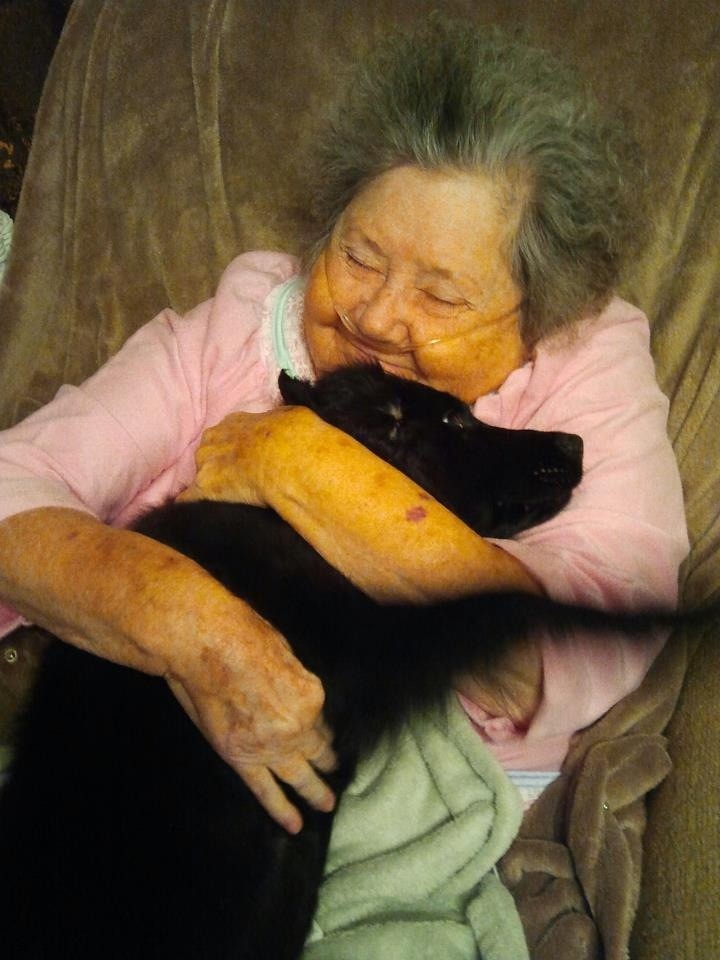 photo of granny hugging dog