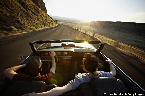 couple driving away in a car