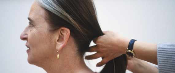 woman pulling out gray hair