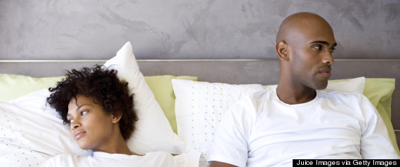 black couple bed unhappy