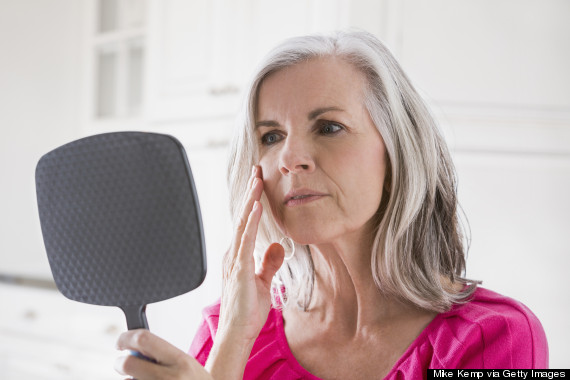 mature woman looking at wrinkles