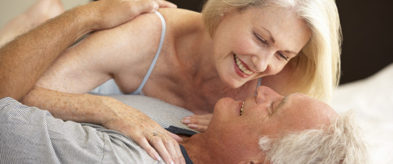 older couple kissing in bed