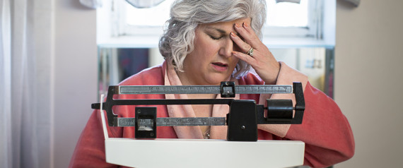 woman standing on weighing scales