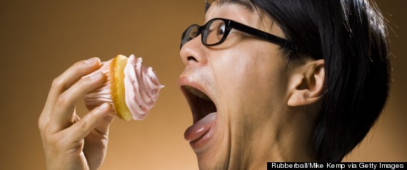 man eating cupcake