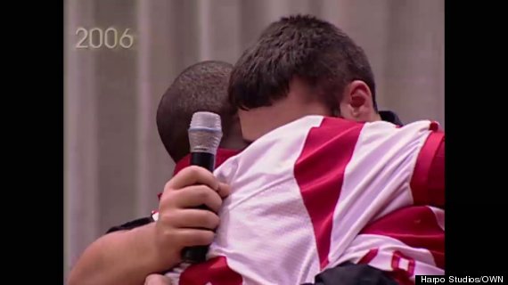 high school football players hugging on oprah