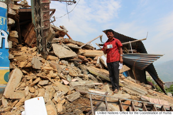 man on rubble at nepal earthquake