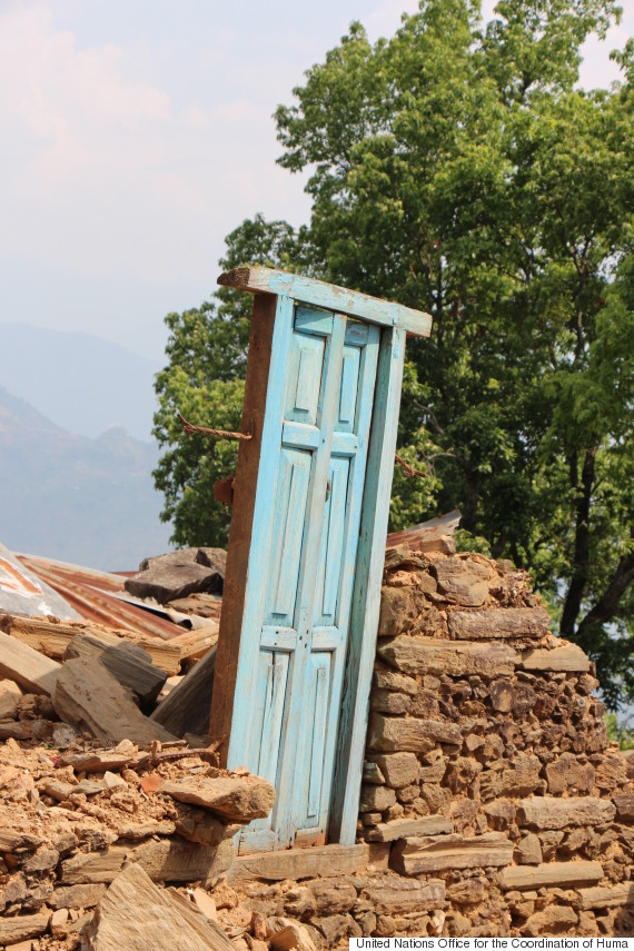 blue door in nepal earthquake rubble