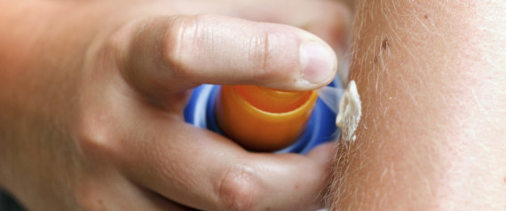 woman rubbing lotion on her hands