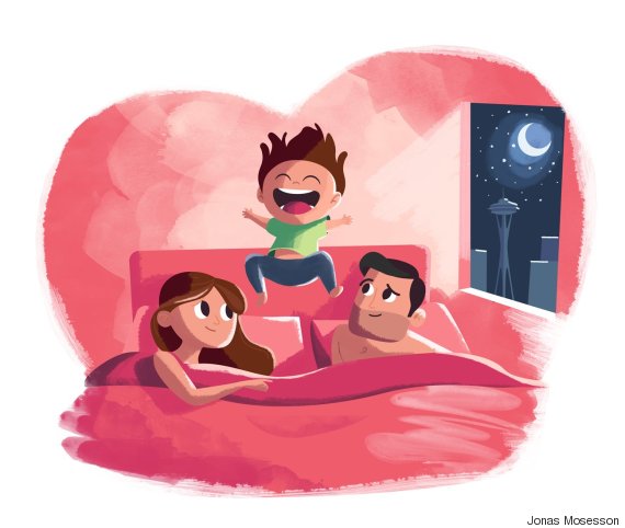 child jumping in bed with parents