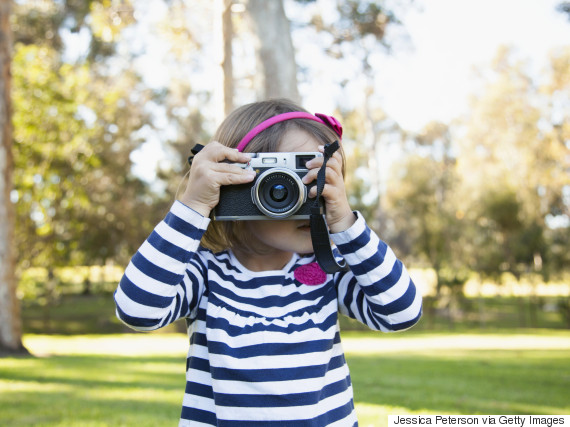 kid holding camera