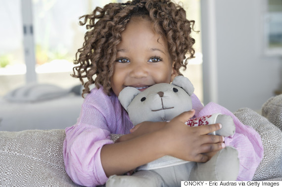 child holding teddy bear