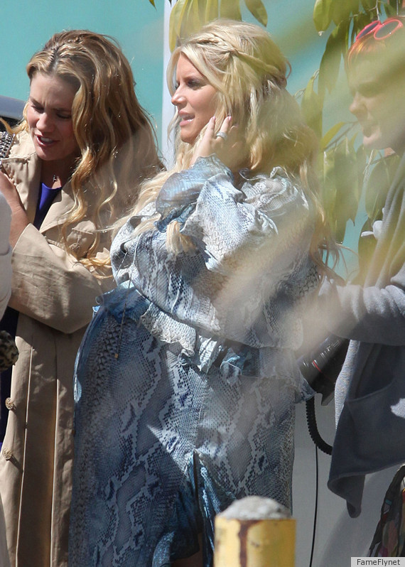 Heavily pregnant Jessica Simpson shows off her baby bump in a very clingy maternity  dress