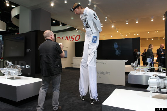 man on stilts detroit auto show 2013